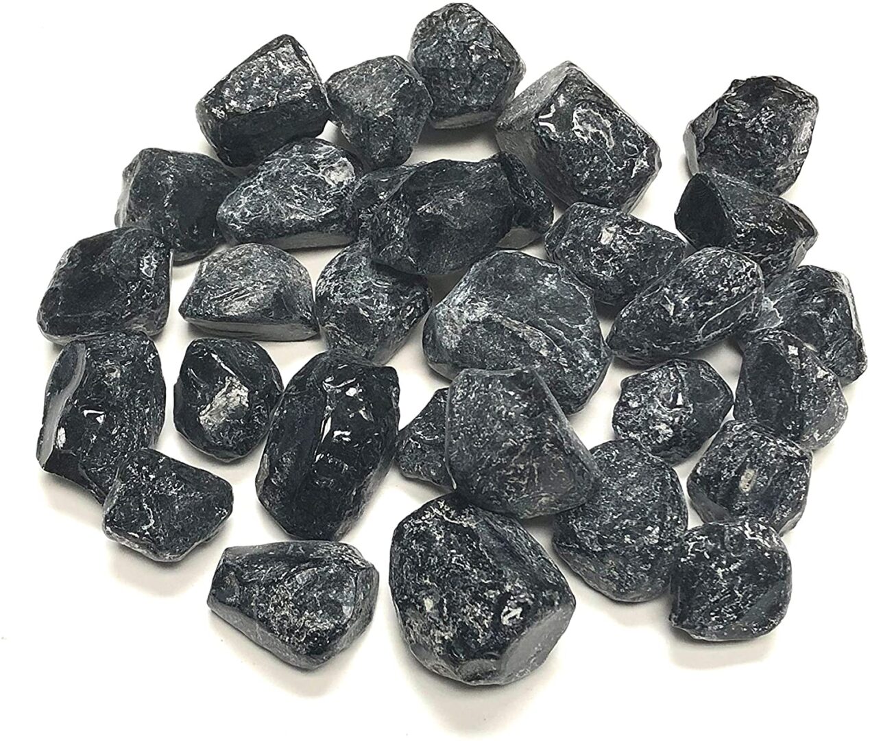 A pile of black rocks on a white background.