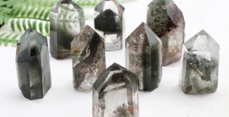 A group of quartz crystal points on a table.