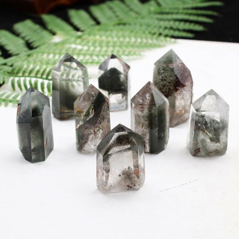 A group of quartz crystal points on a table.