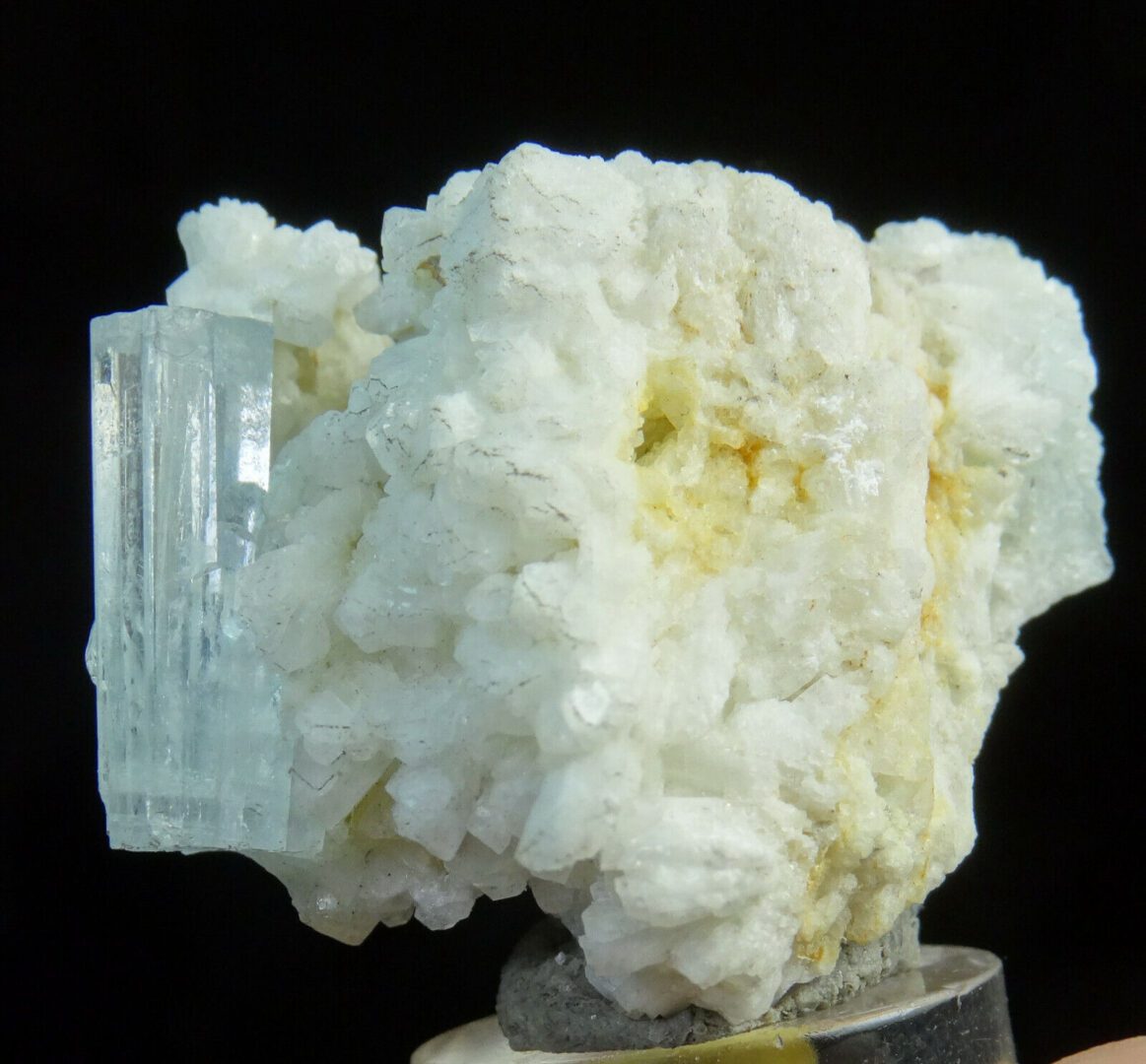 A piece of white quartz with a white crystal on it.