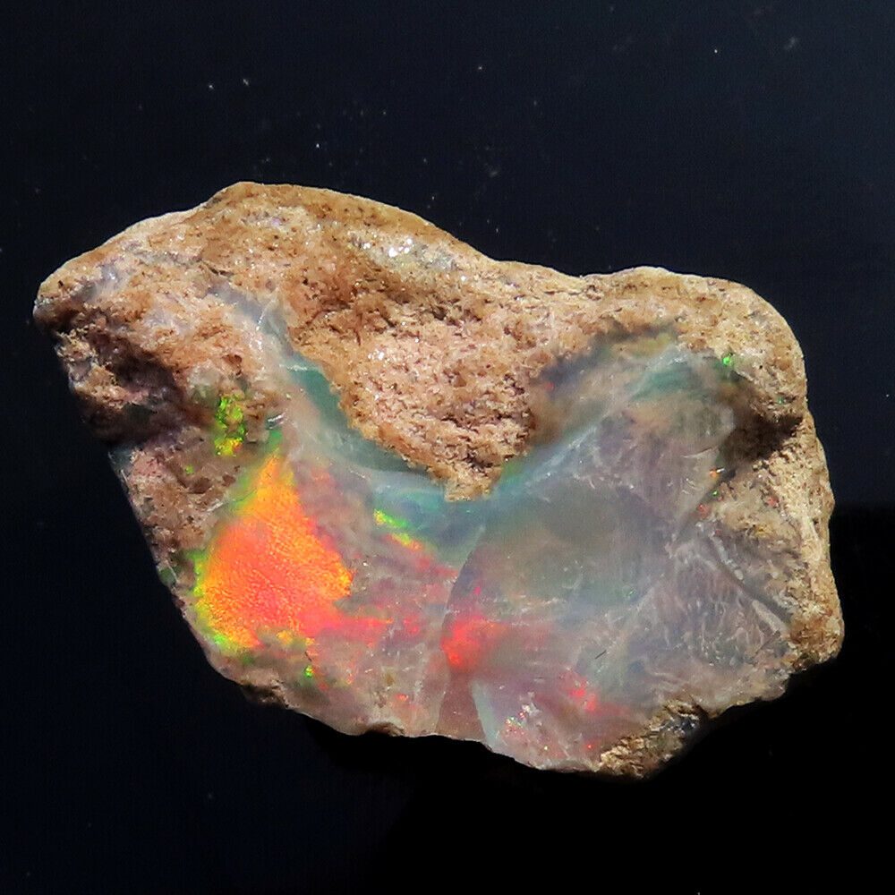 A rock with a piece of opal on it.