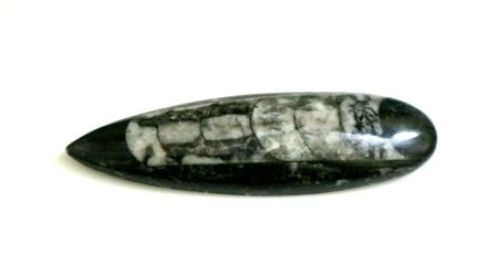 A black and white stone on a white surface.