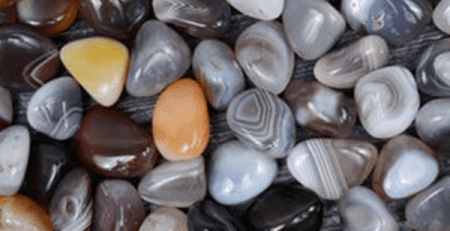 A pile of different colored agate stones in color white color.