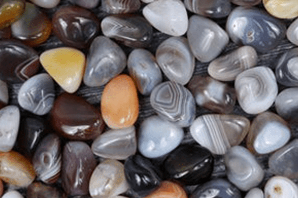 A pile of different colored agate stones in color white color.