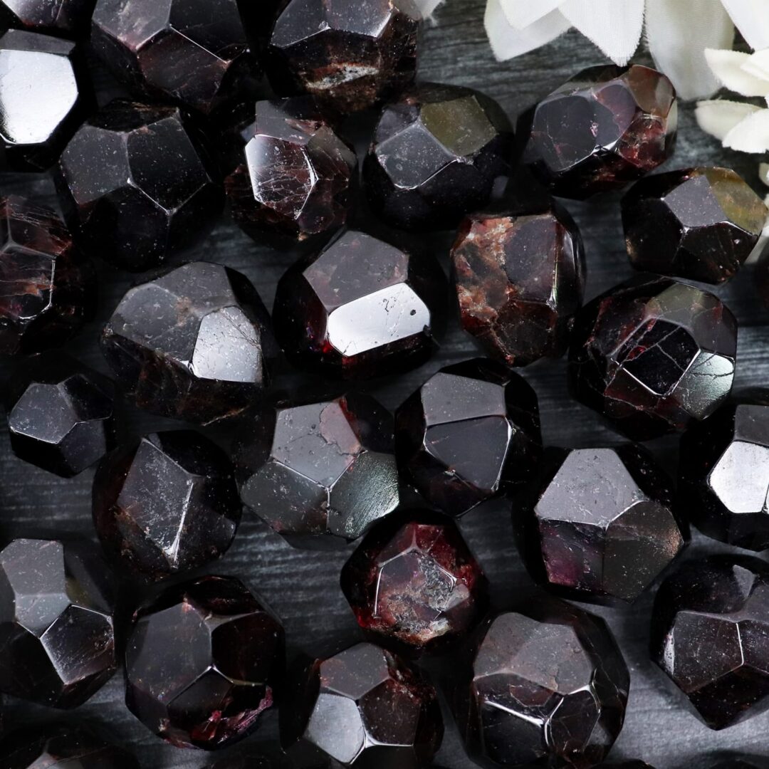 A bunch of black garnet stones on a table in color