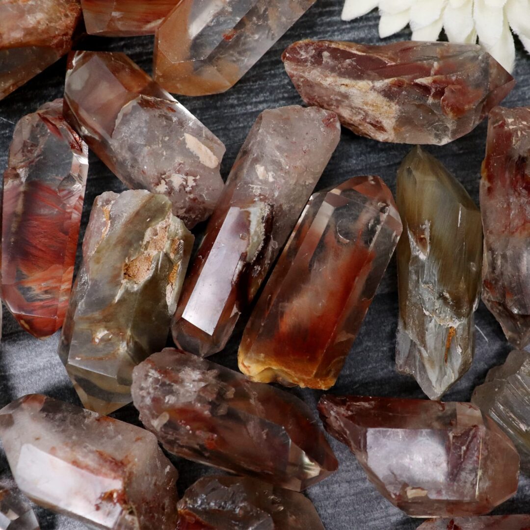 A bunch of quartz crystals on a table in brown color