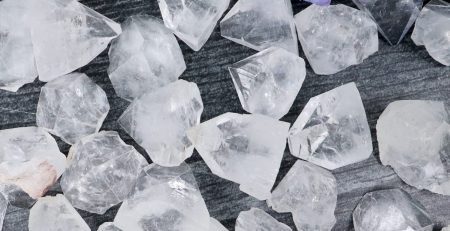 A pile of crystals and flowers on a table.