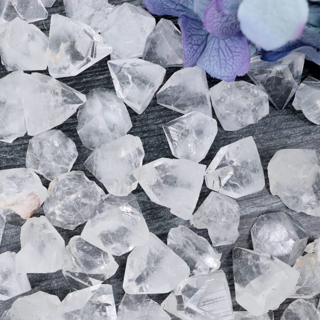 A pile of crystals and flowers on a table.