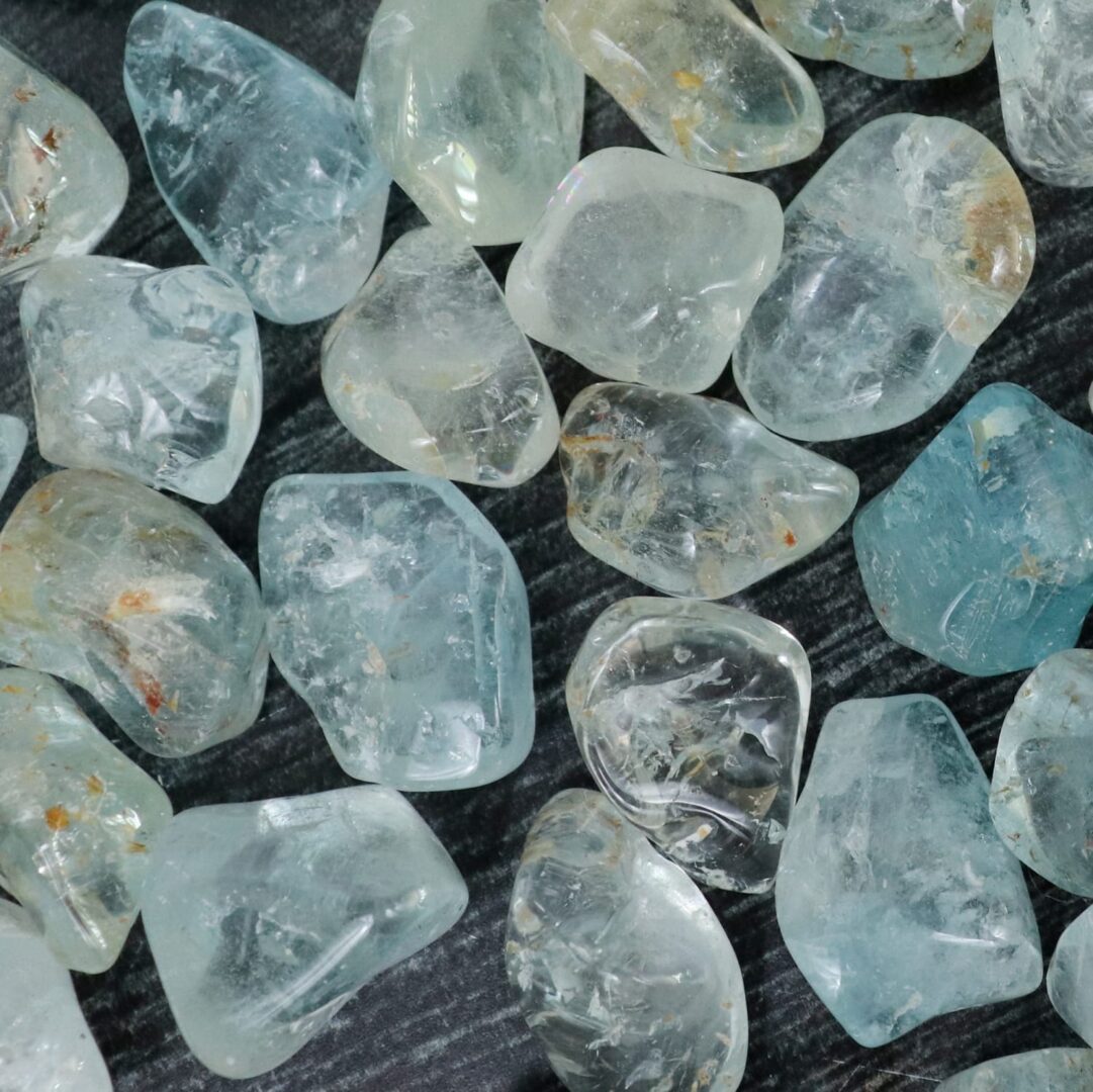 A bunch of aquamarine crystals on a table.