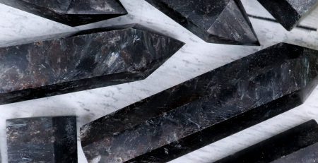 A group of black marble points on a white surface.