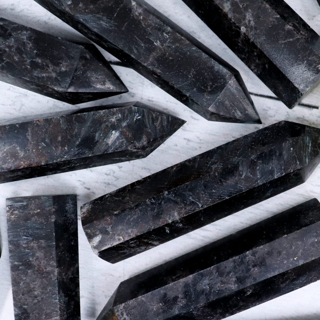 A group of black marble points on a white surface.