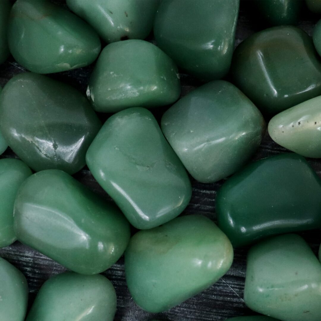 A pile of green jade stones on a table.