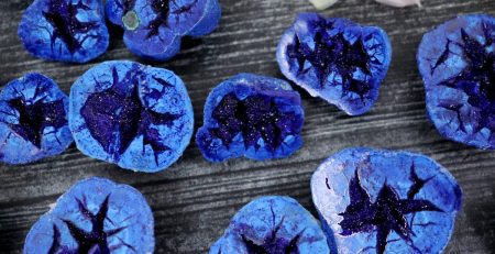 A bunch of blue stones on a table.