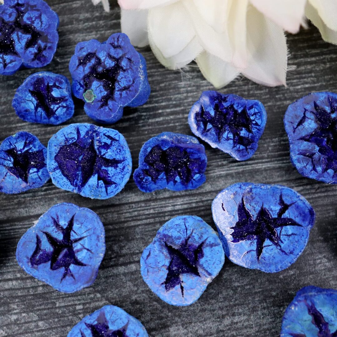 A bunch of blue stones on a table.