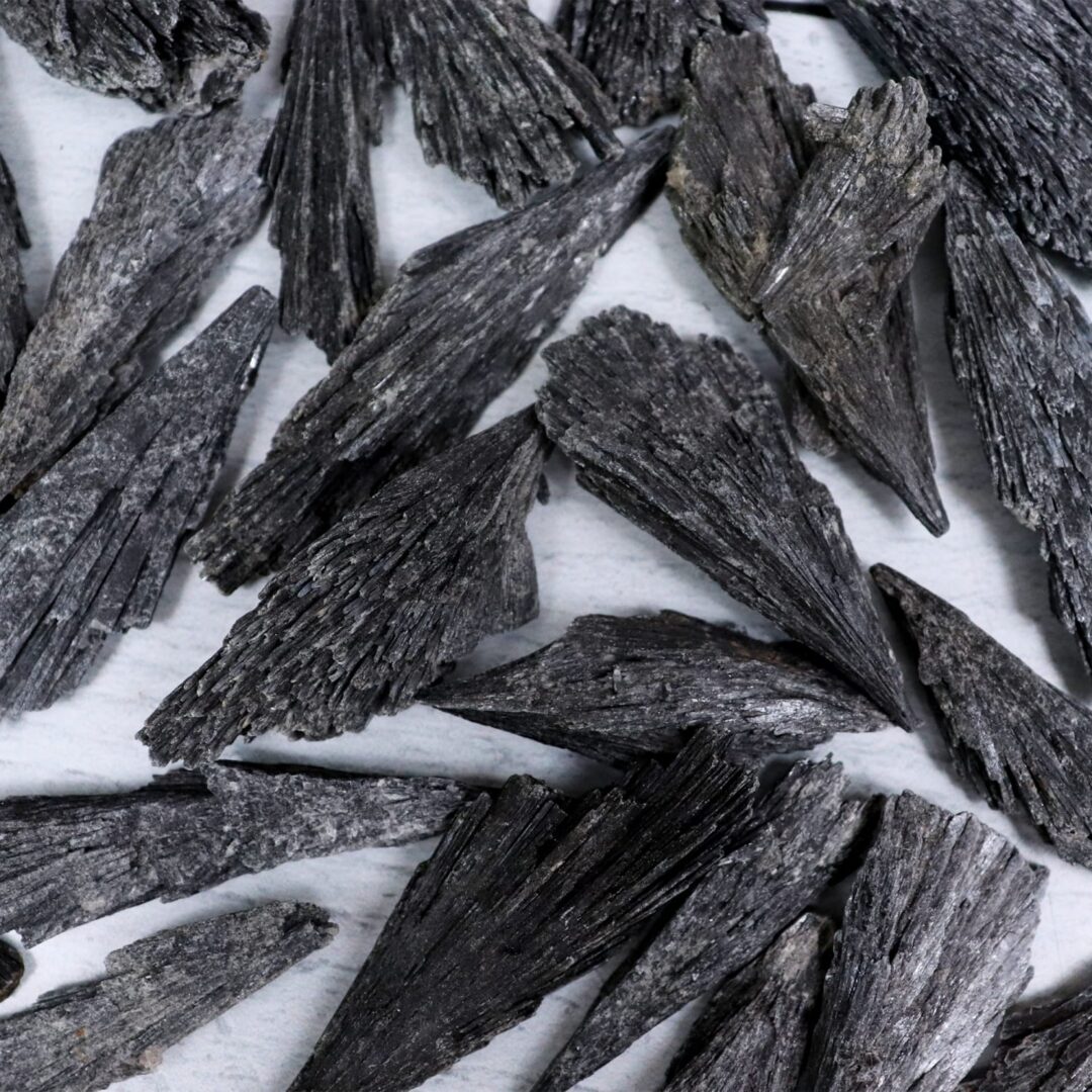 A pile of black rocks on a white surface.