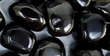 A pile of black stones on a table.