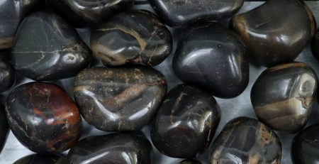 A pile of black and brown stones on a table.