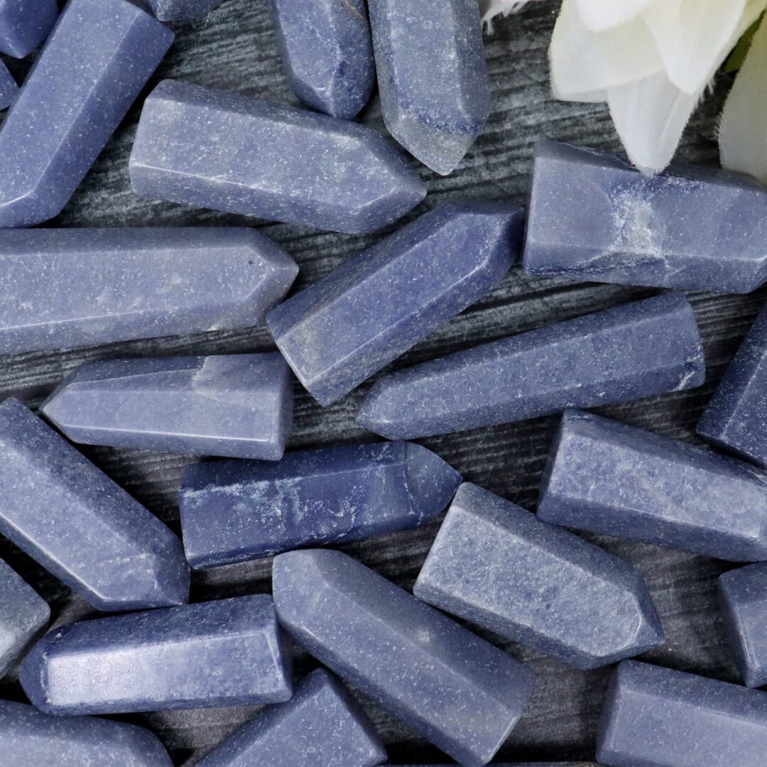 A bunch of blue quartz crystals on a wooden surface.