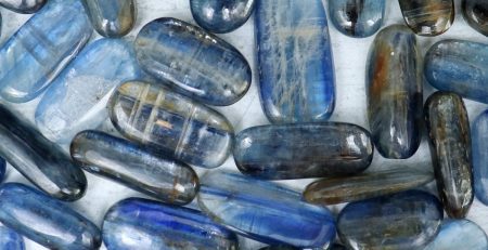 A group of blue and gray stones on a white surface.