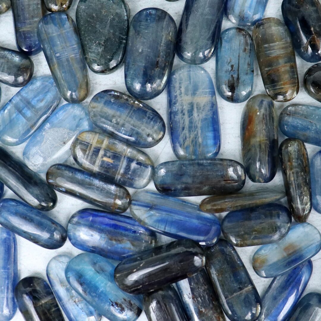 A group of blue and gray stones on a white surface.