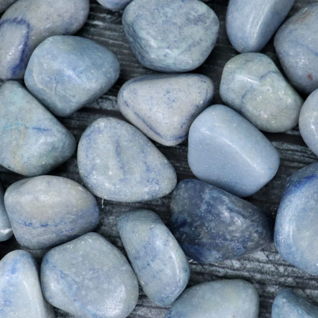 A pile of blue stones on a wooden surface.