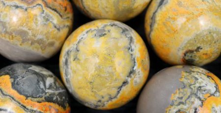 A group of yellow and black marble spheres.