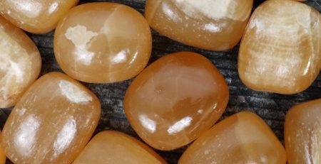 A group of yellow quartz cubes on a wooden surface.