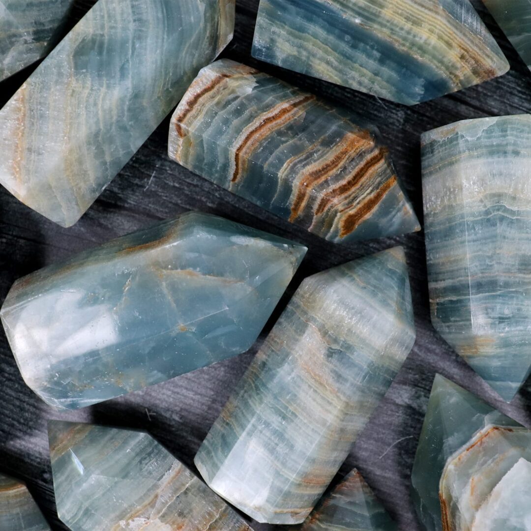 A group of blue apatite stones on a table.