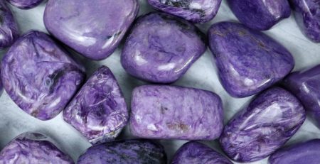 A pile of purple stones on a white surface.