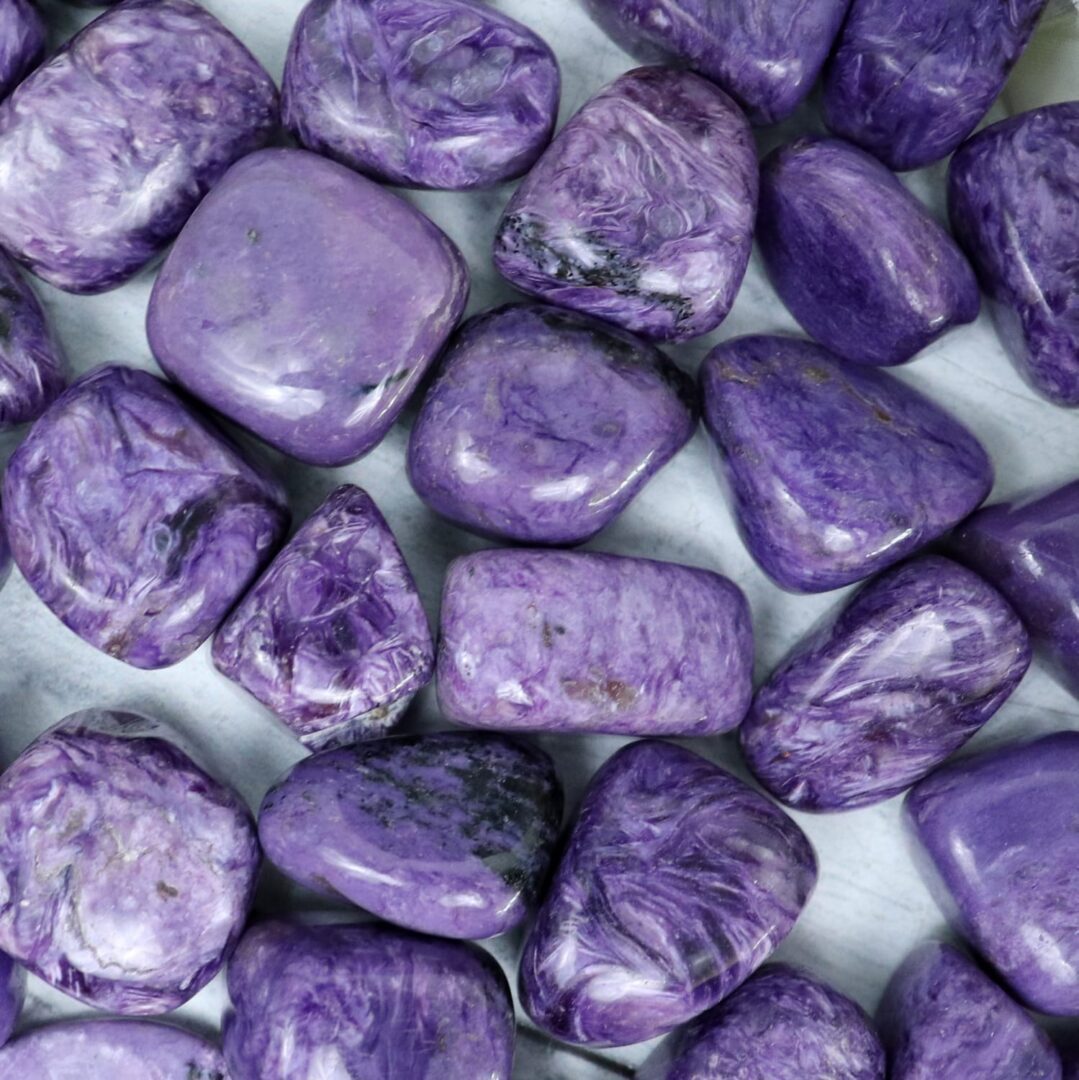 A pile of purple stones on a white surface.