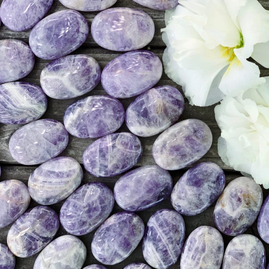 Purple amethyst gemstones on a wooden table.