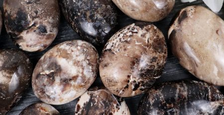 A group of black and white marble eggs on a table.