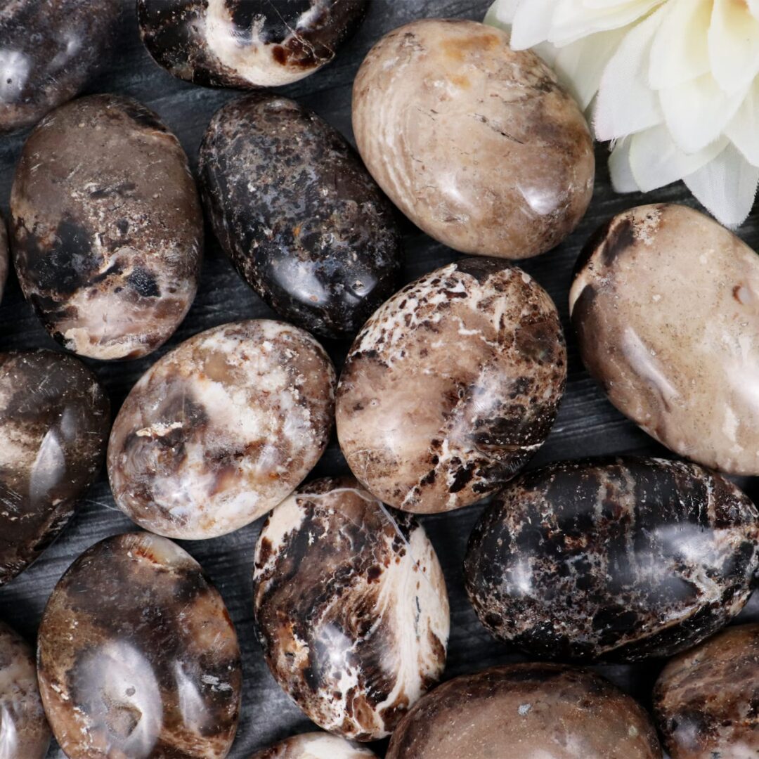 A group of black and white marble eggs on a table.