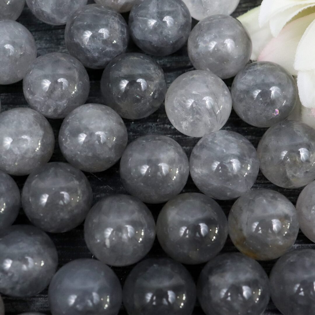 A bunch of grey quartz spheres on a table.