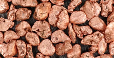 Copper pebbles on a black background.