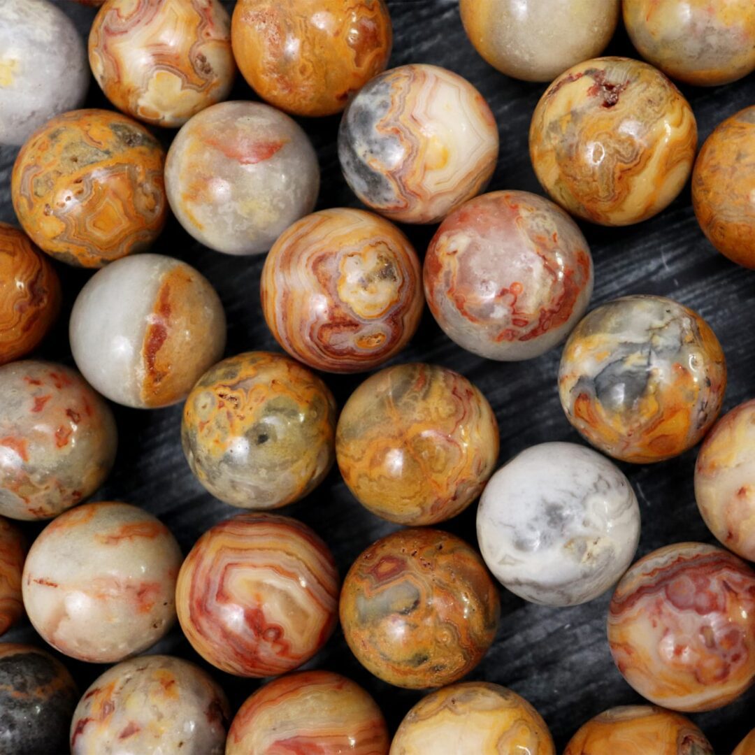 A bunch of brown and yellow marble beads on a table.