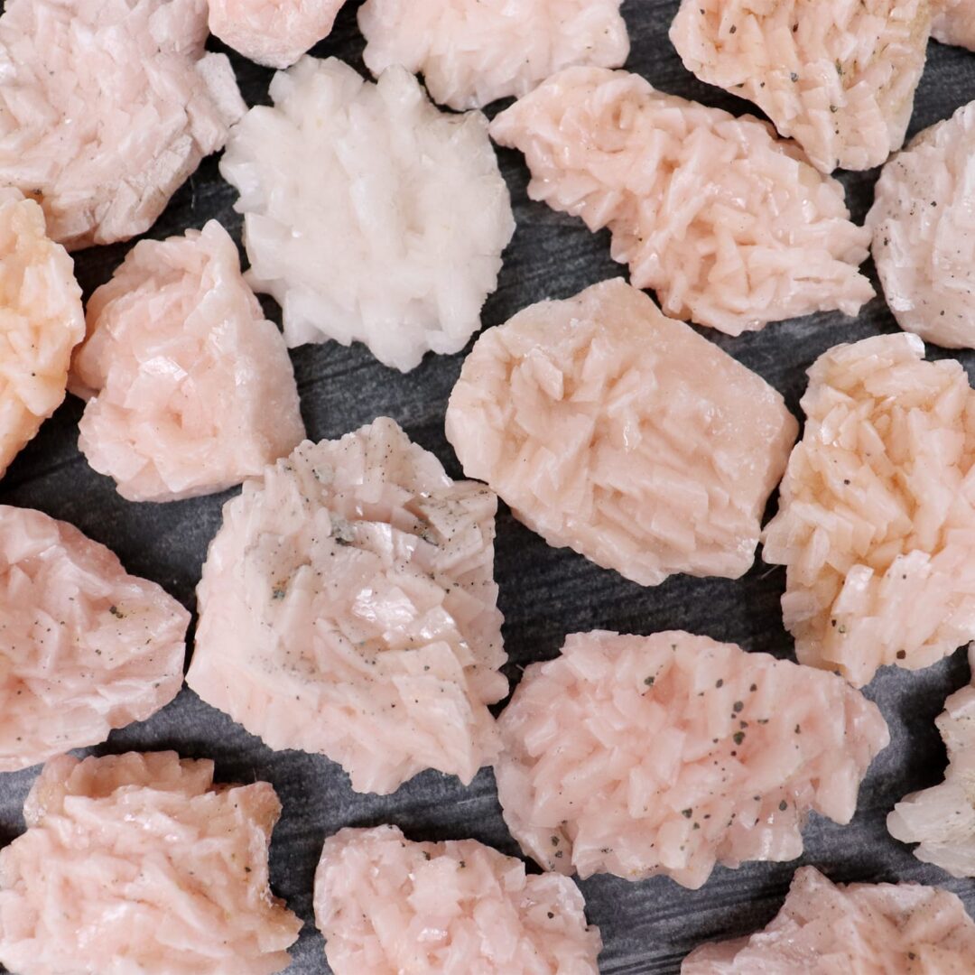 A pile of pink crystals on a black background.