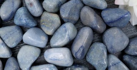 A pile of blue stones with a flower in the middle.