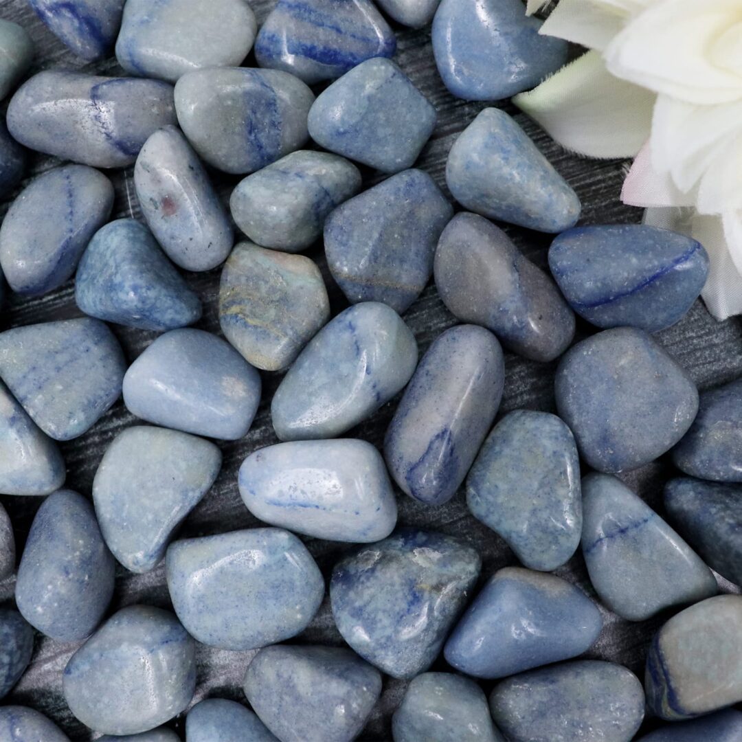 A pile of blue stones with a flower in the middle.