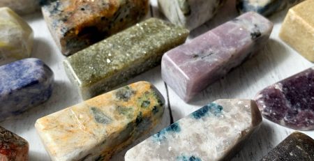 A variety of different colored stones on a table.