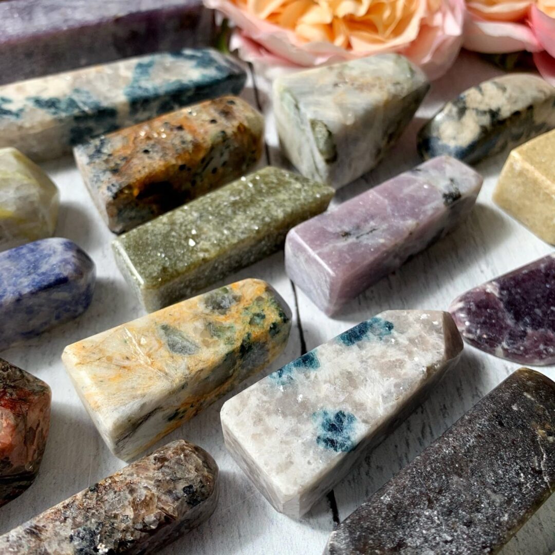 A variety of different colored stones on a table.