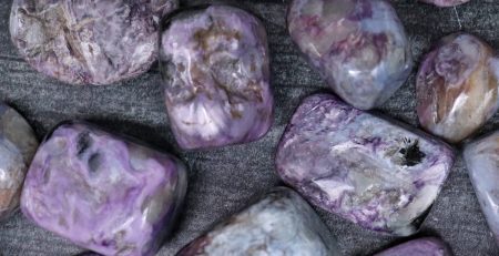 Purple amethyst stones on a black surface.