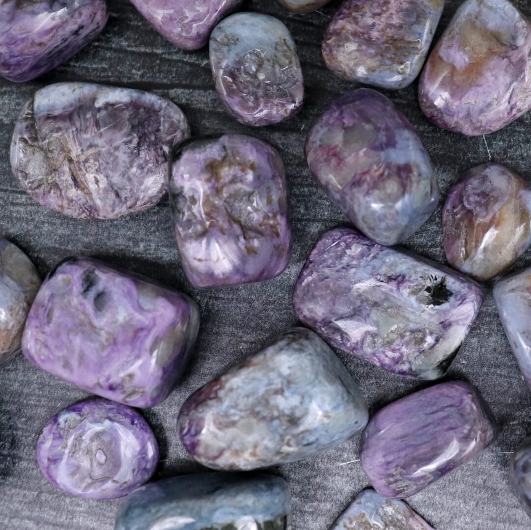 Purple amethyst stones on a black surface.