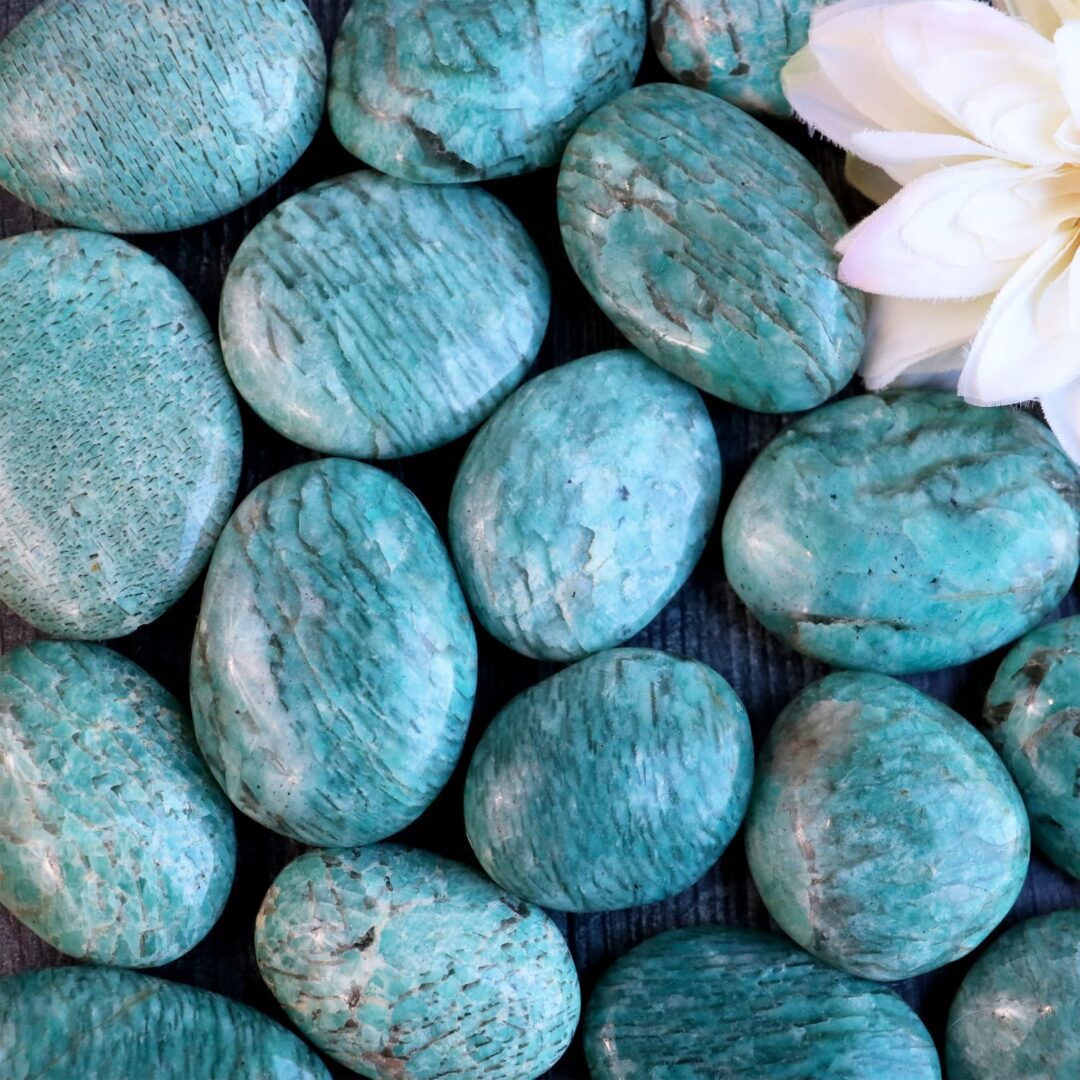 A bunch of turquoise stones with a flower in the middle.