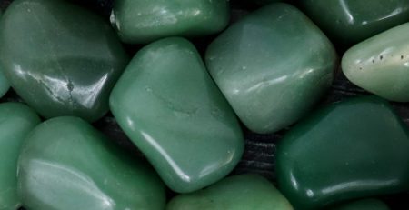 A pile of green jade stones on a table.