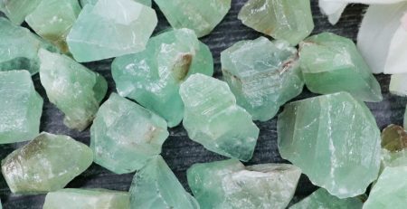 A bunch of green crystals on a table.