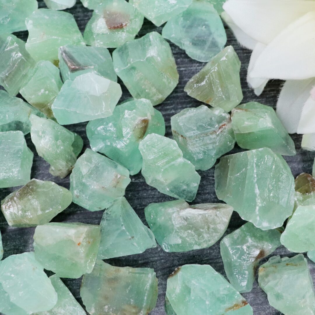 A bunch of green crystals on a table.