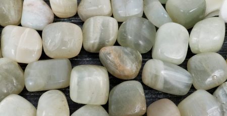 A bunch of green and white stones on a table.