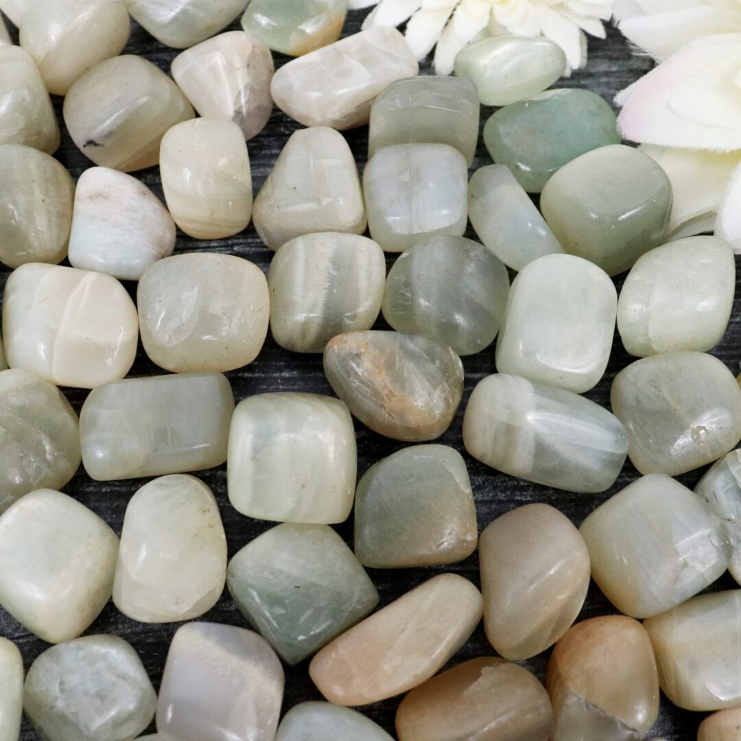 A bunch of green and white stones on a table.