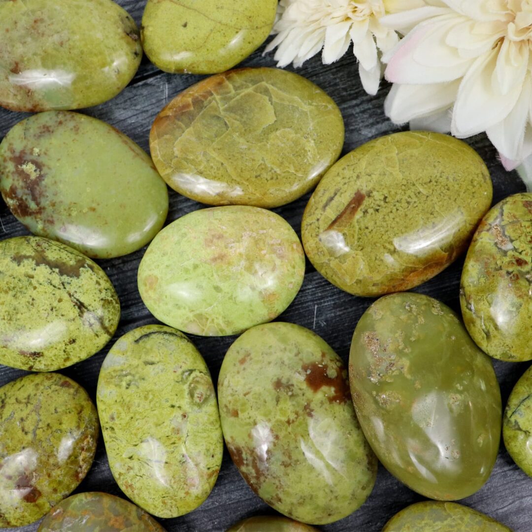 A bunch of green stones with flowers on them.